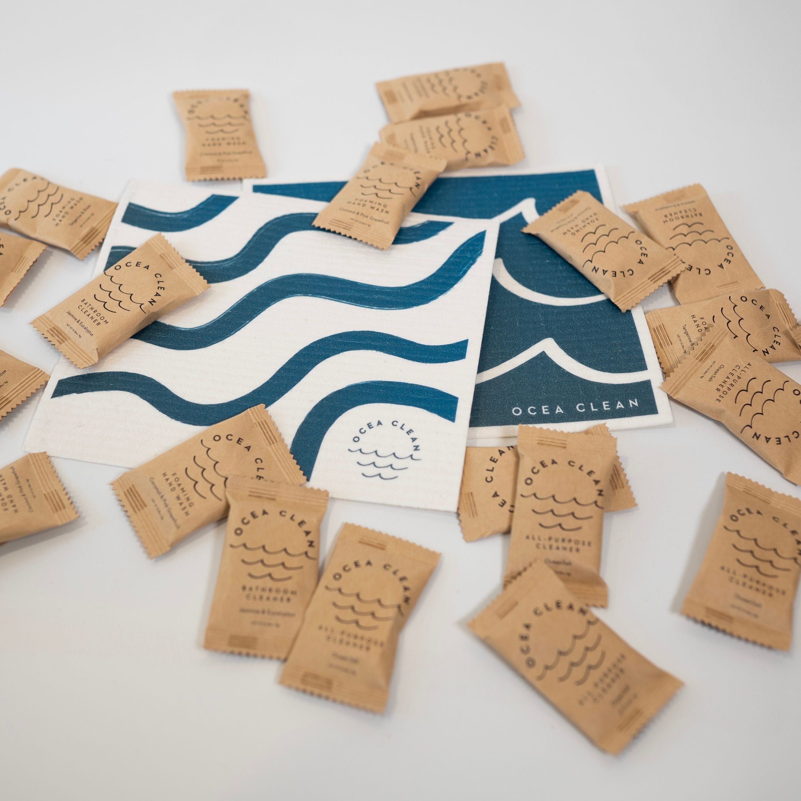 REFILLS & TOP-UPS: Plant based dissolvable cleaning tablets on a blue wave design background.