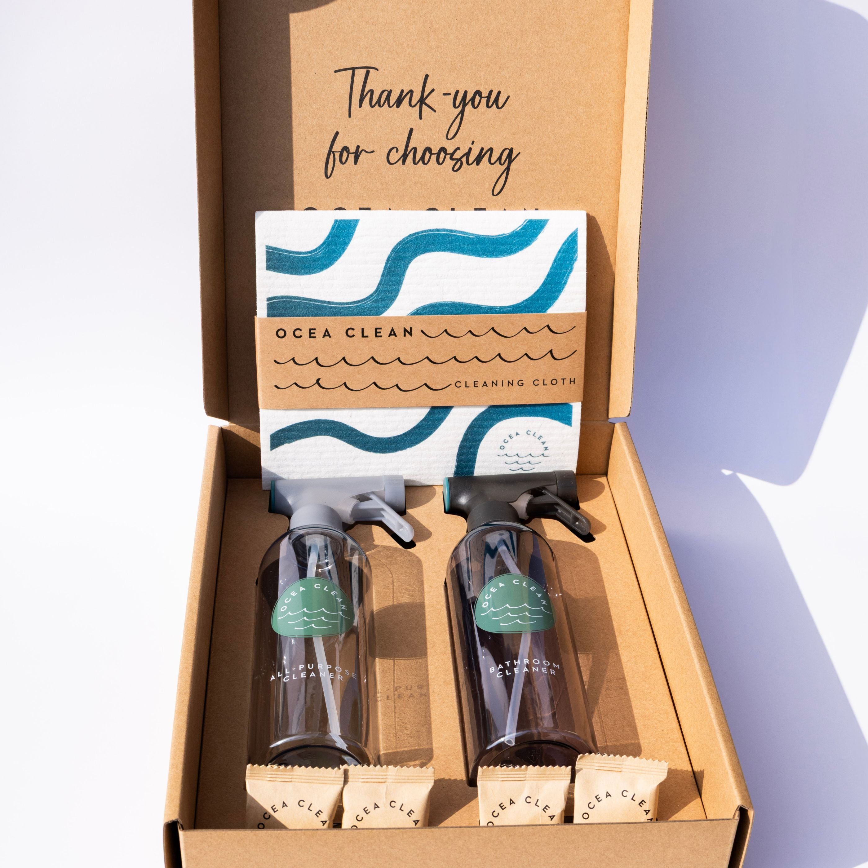 Ocea Clean cleaning kit with bottles, cloths, and a box