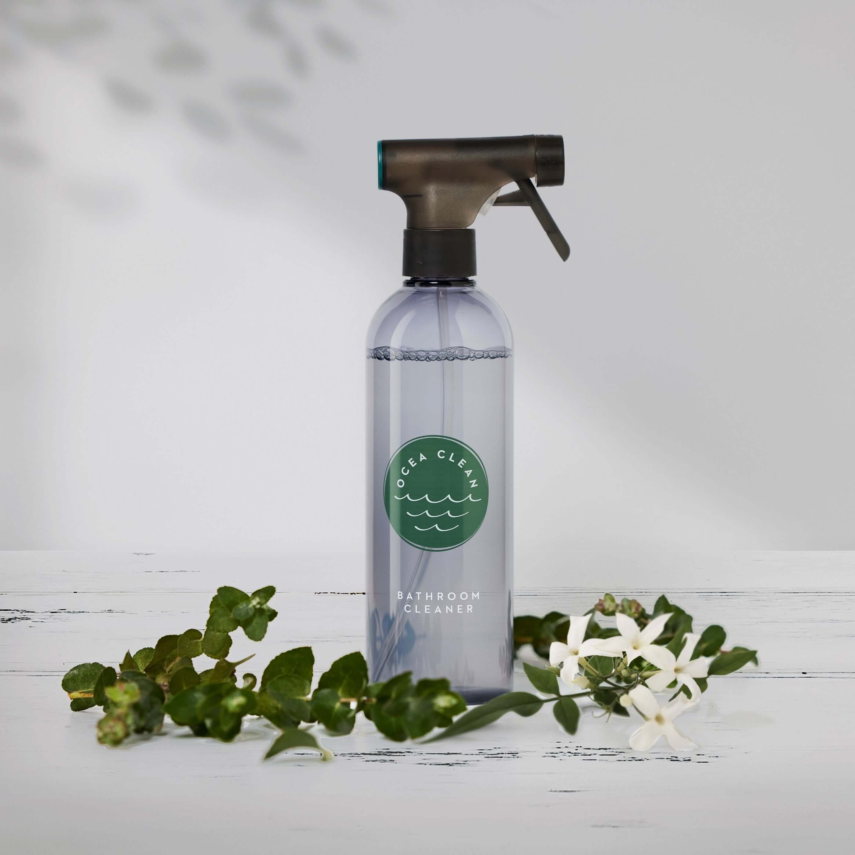 Ocea Clean Bathroom Cleaner Kit in a spray bottle surrounded by greenery, showcasing eco-friendly and non toxic cleaning products.