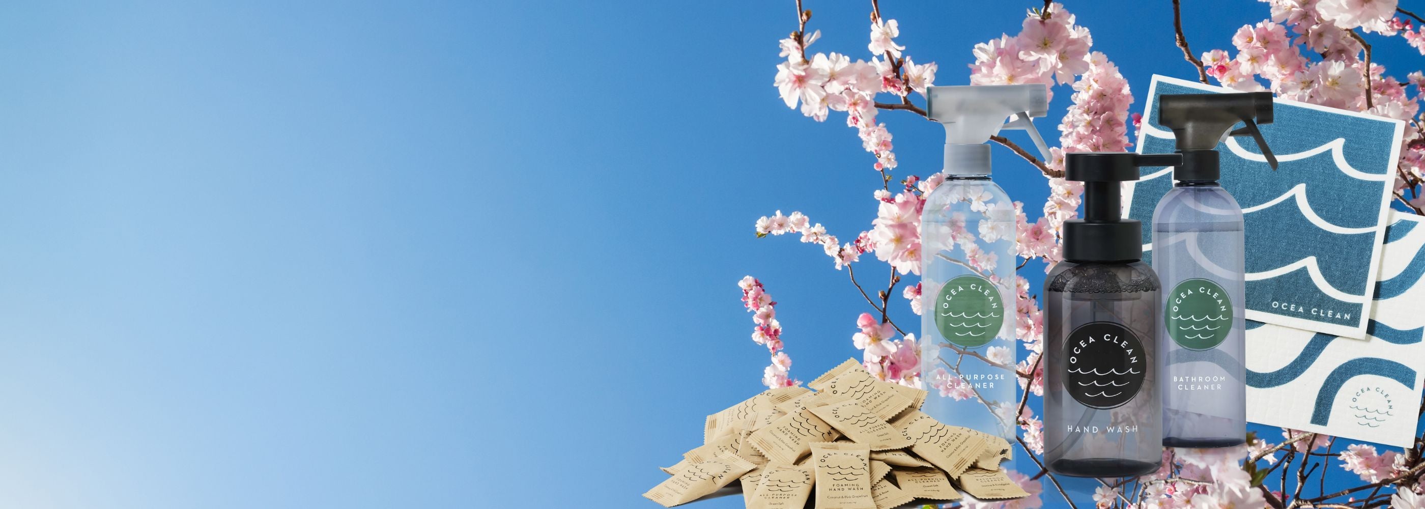 Three bottles of cleaning products with cherry blossoms and a blue sky background