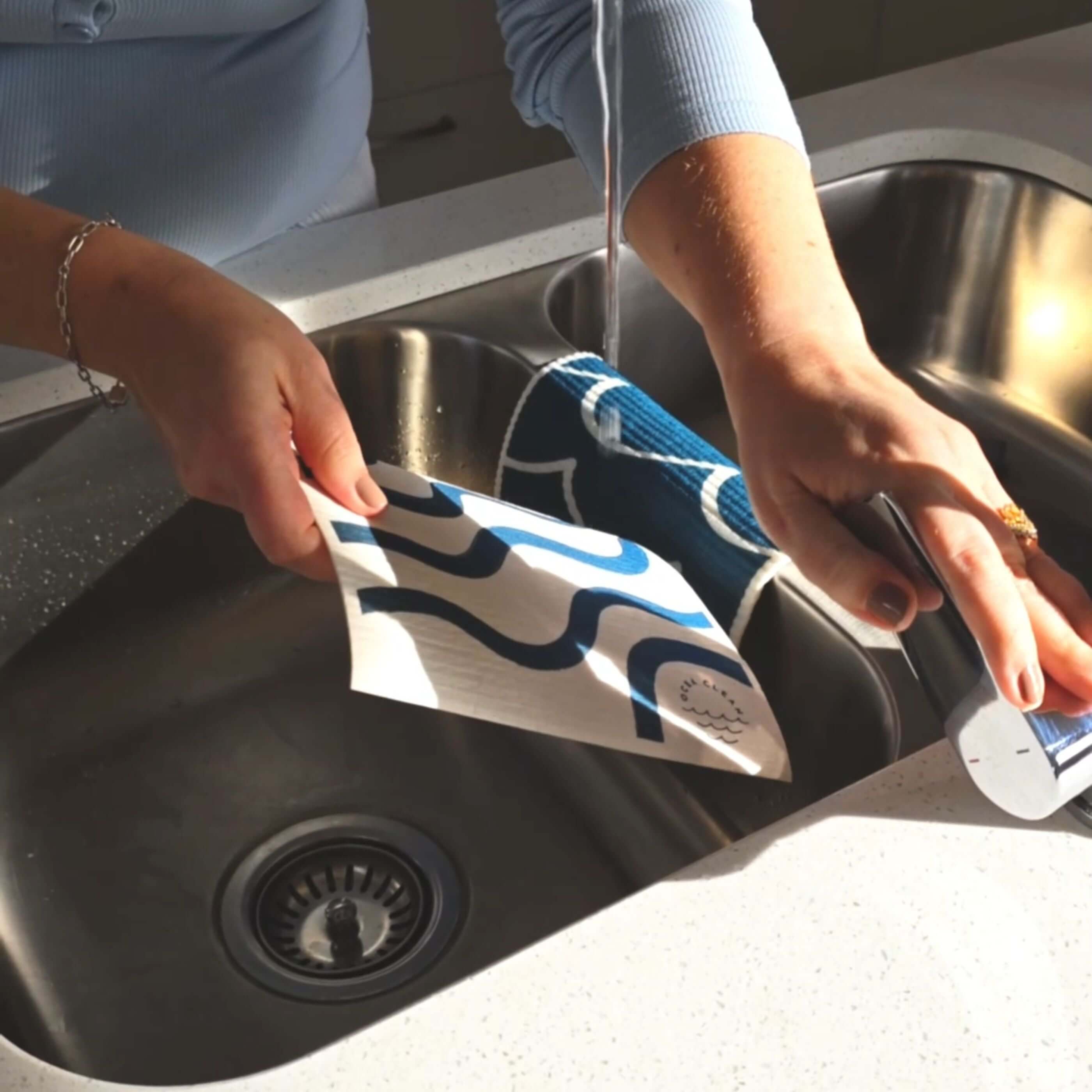 Ocea Clean Cleaning Cloth Refill – 2 Pack being used at the sink for eco friendly cleaning.