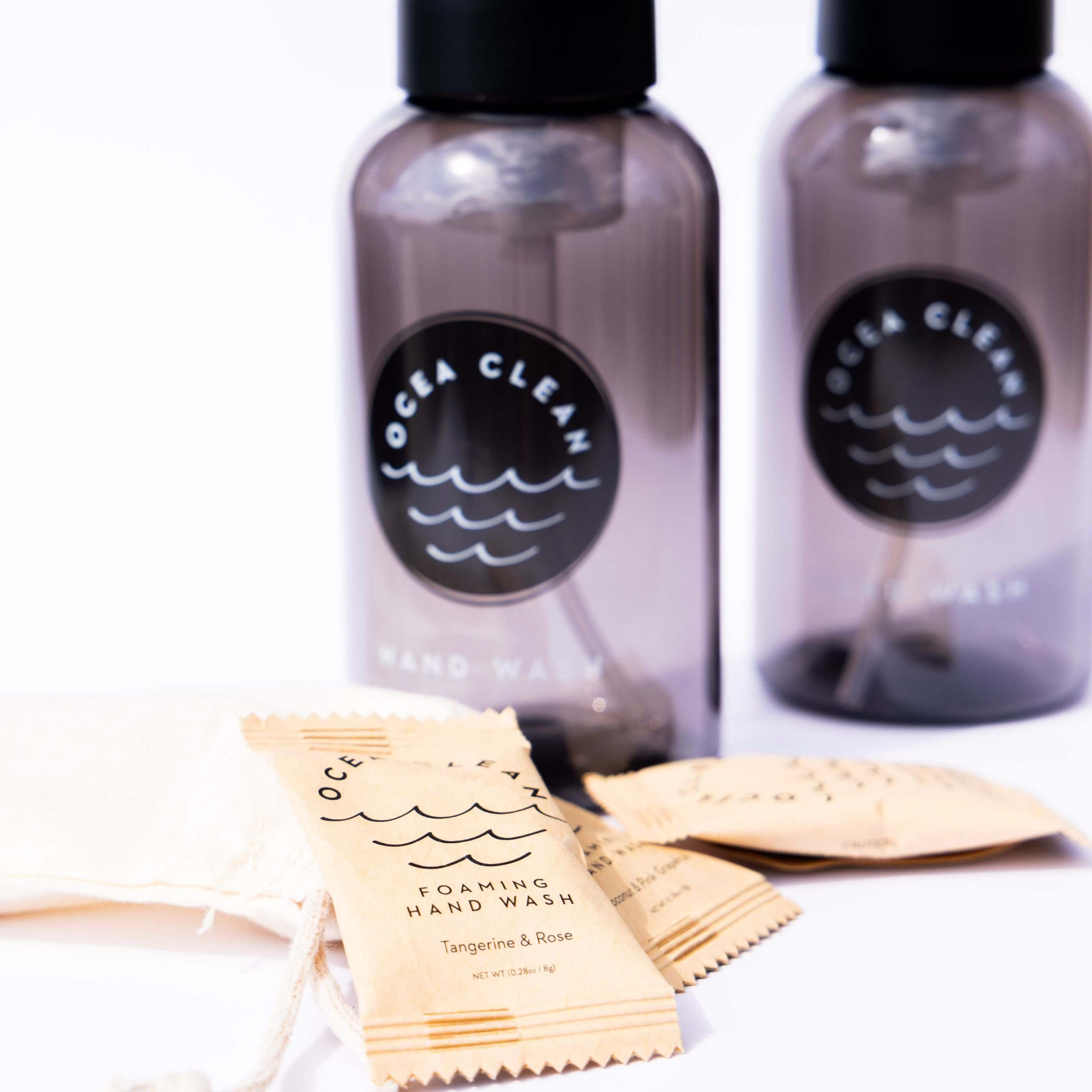 Ocea Clean Hand Wash Pack featuring refillable dispensers and foaming hand wash packets in Tangerine & Rose.