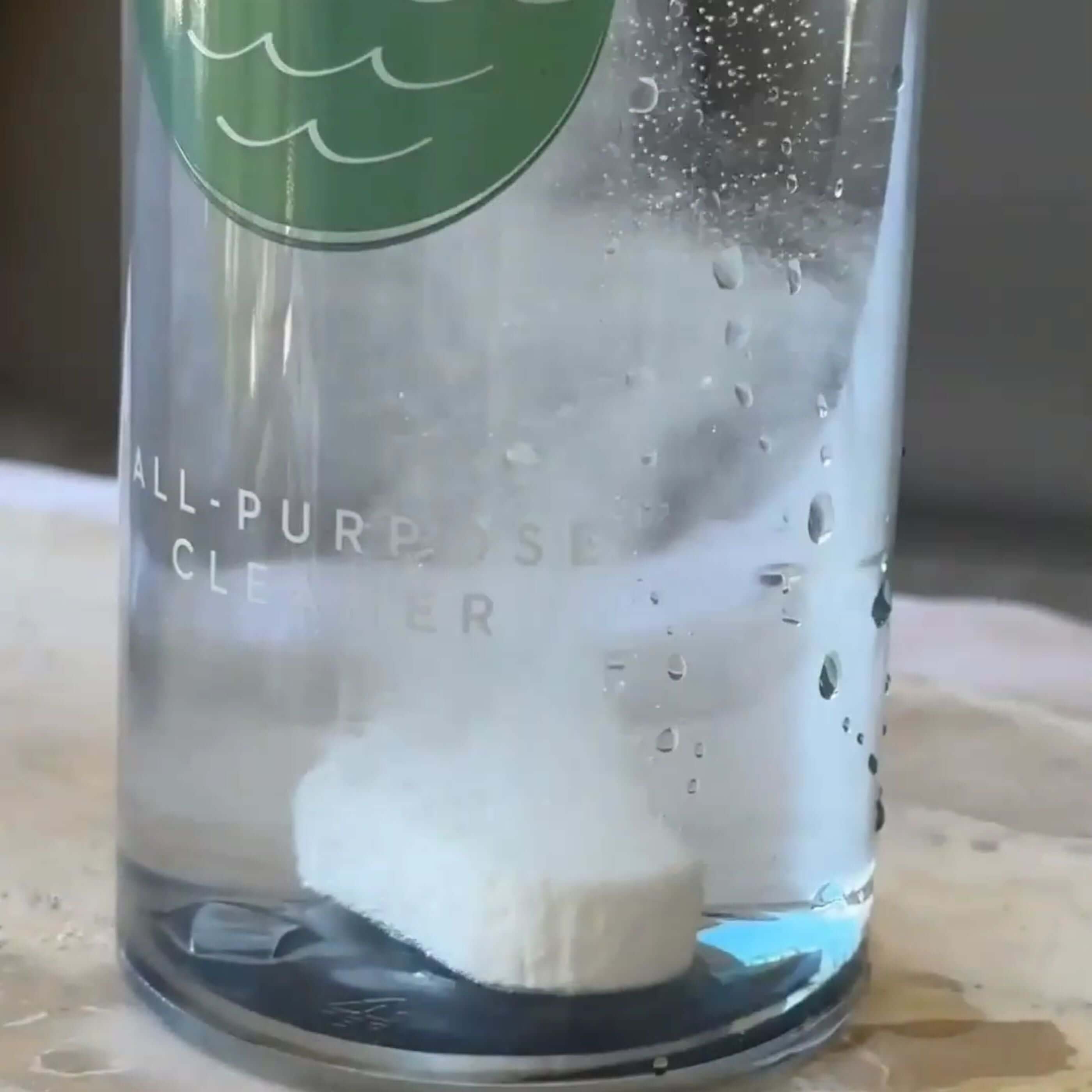 Ocea Clean All-Purpose Cleaner Kit dissolving tablet in water, showcasing eco friendly cleaning products.