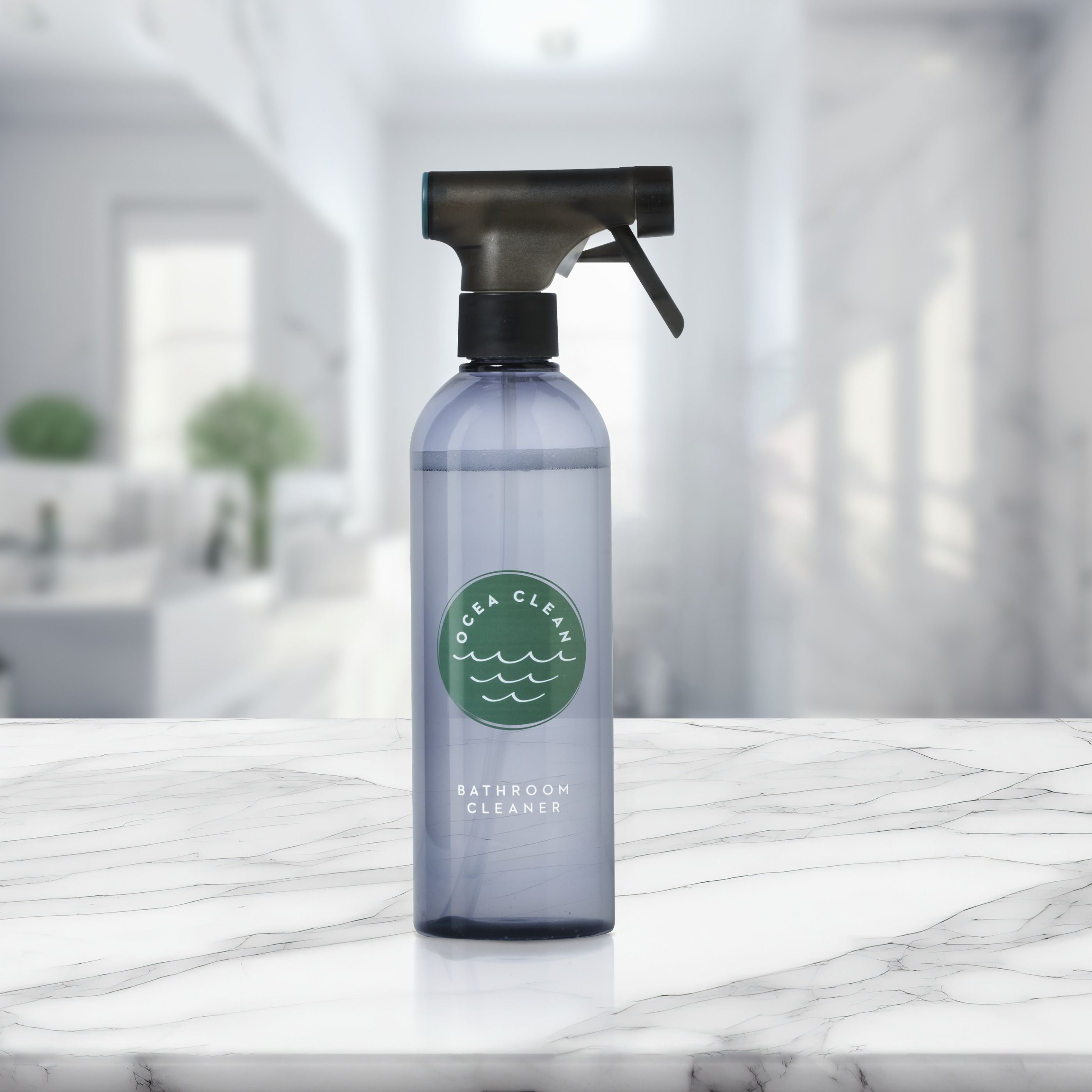 Bottle of bathroom cleaner on a marble surface with a blurred bathroom background